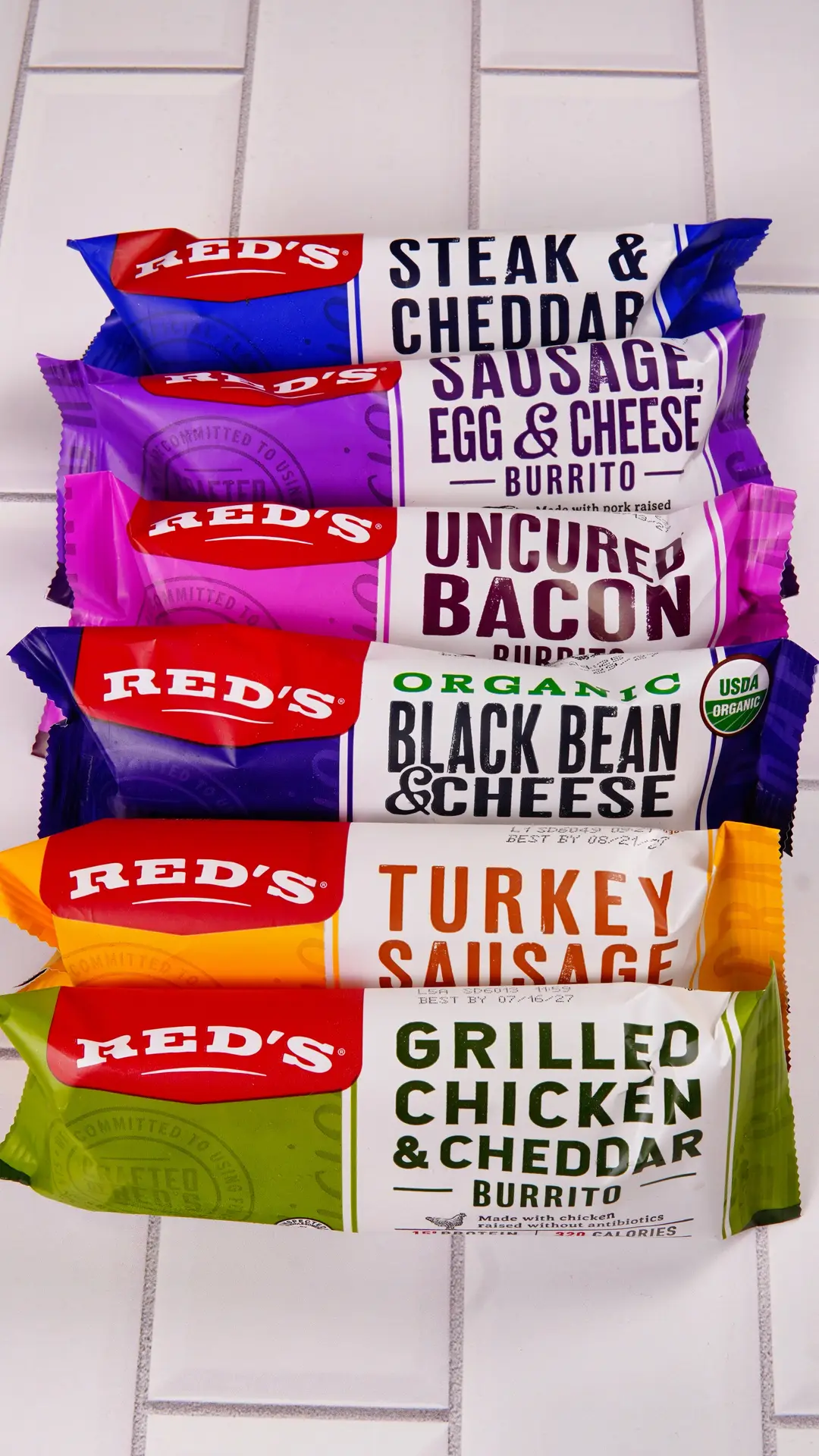 Red's All Natural burrito packages in various flavors including Steak & Cheddar and Organic Black Bean & Cheese.